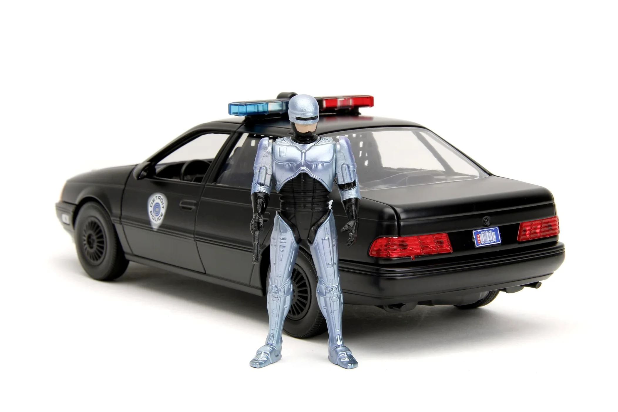 Jada - Robocop 1986 Ford Taurus, 253225060, +8 anni, in metallo pressofuso, in scala 1:24, parti apribili, sistema a ruota libera, personaggio incluso